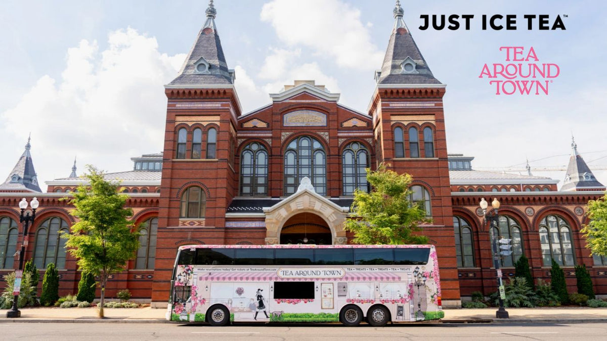 Tea Around Town bus parked in front of a historic brick building with Just Ice Tea and Tea Around Town branding